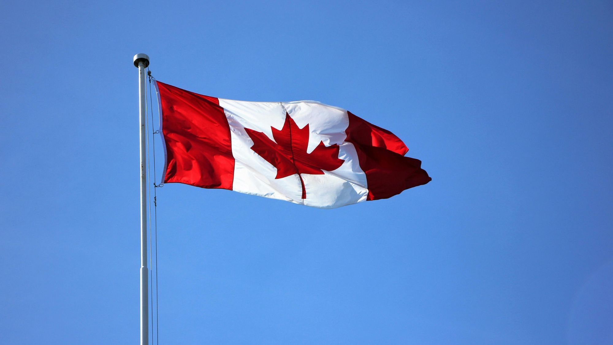 A waving Canadian flag symbolising the Cheapest provinces to live in Canada in 2026 for affordable living