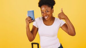 A woman holding a temporary visa in her hand going to get PR in Canada