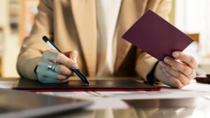 Female lawyer reviewing documents with a Canadian passport for undocumented immigrants legal status in Canada