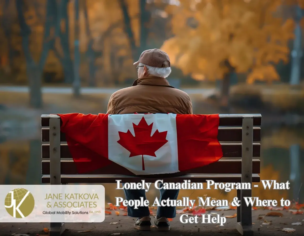 An elderly man sits alone on a park bench in autumn, viewed from behind, with a Canadian flag draped across the backrest.